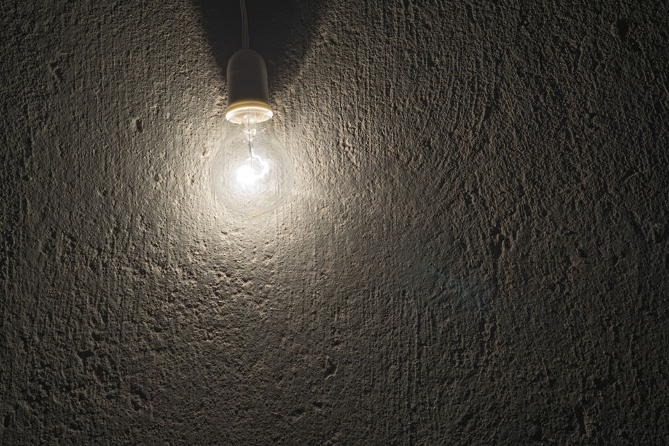 electric bulb on a rough concrete wall